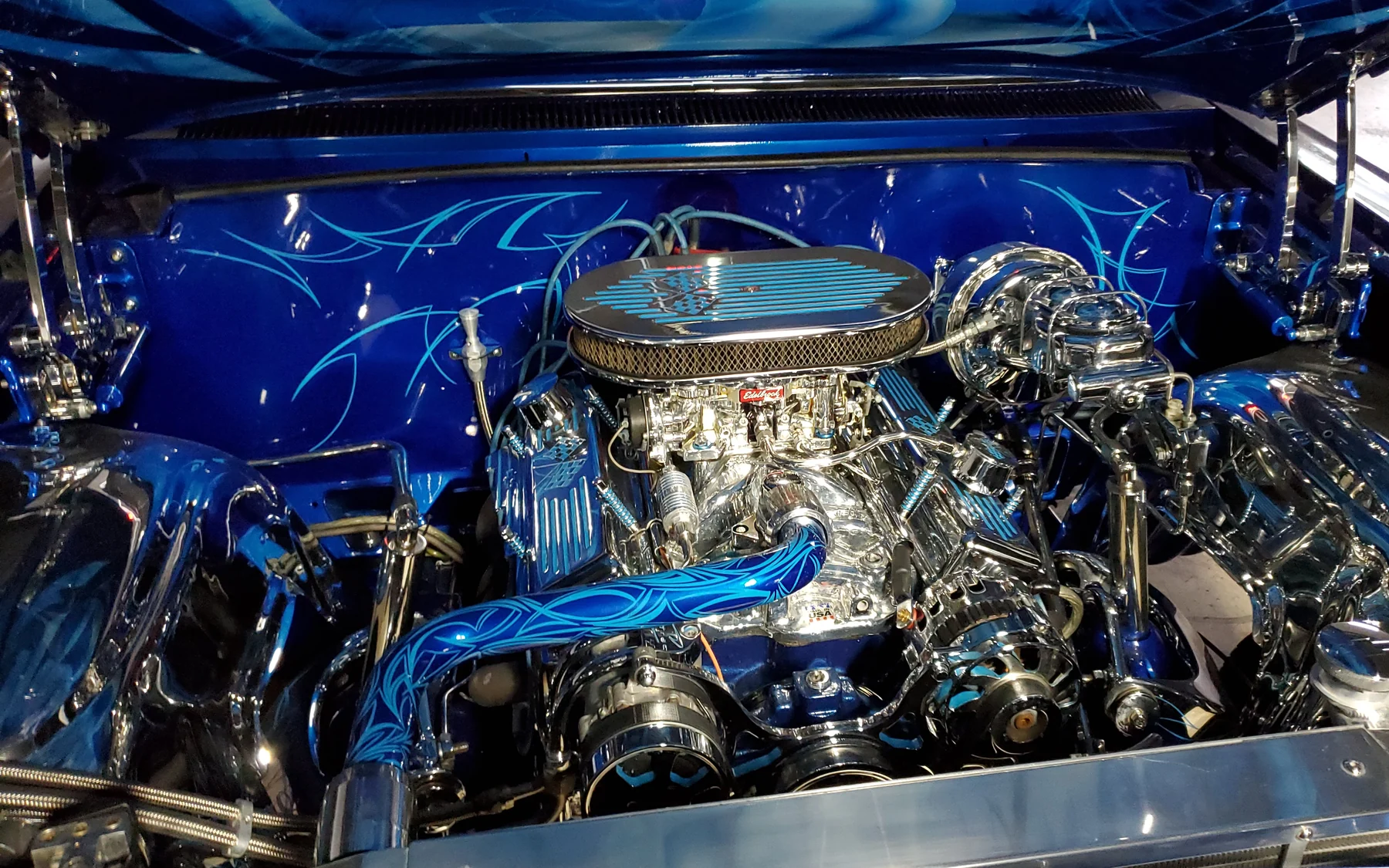 Polished custom engine installation against a blue patterned engine bay