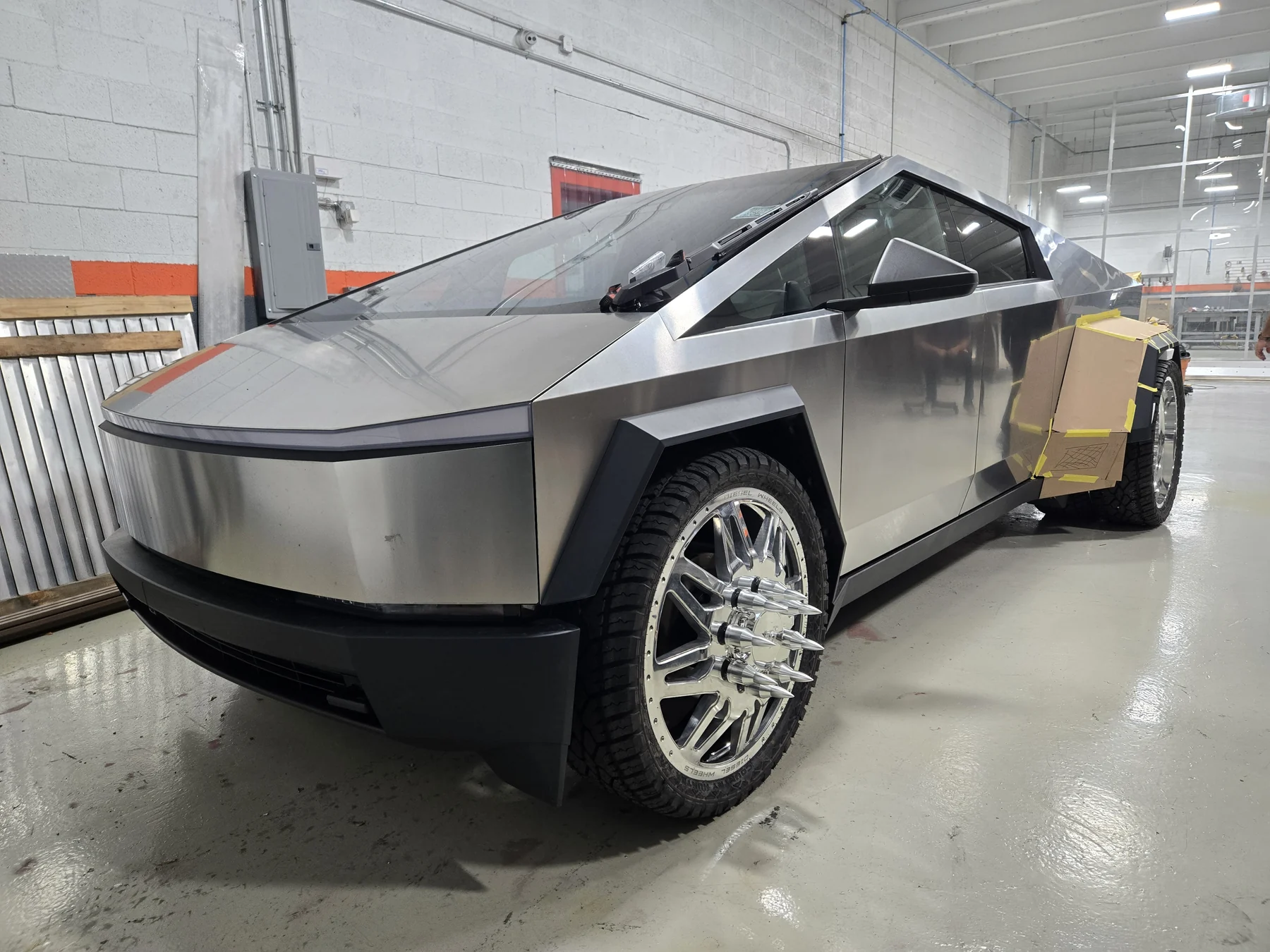 Cyber Dos build in a workshop front three-quarter view with polished wheels
