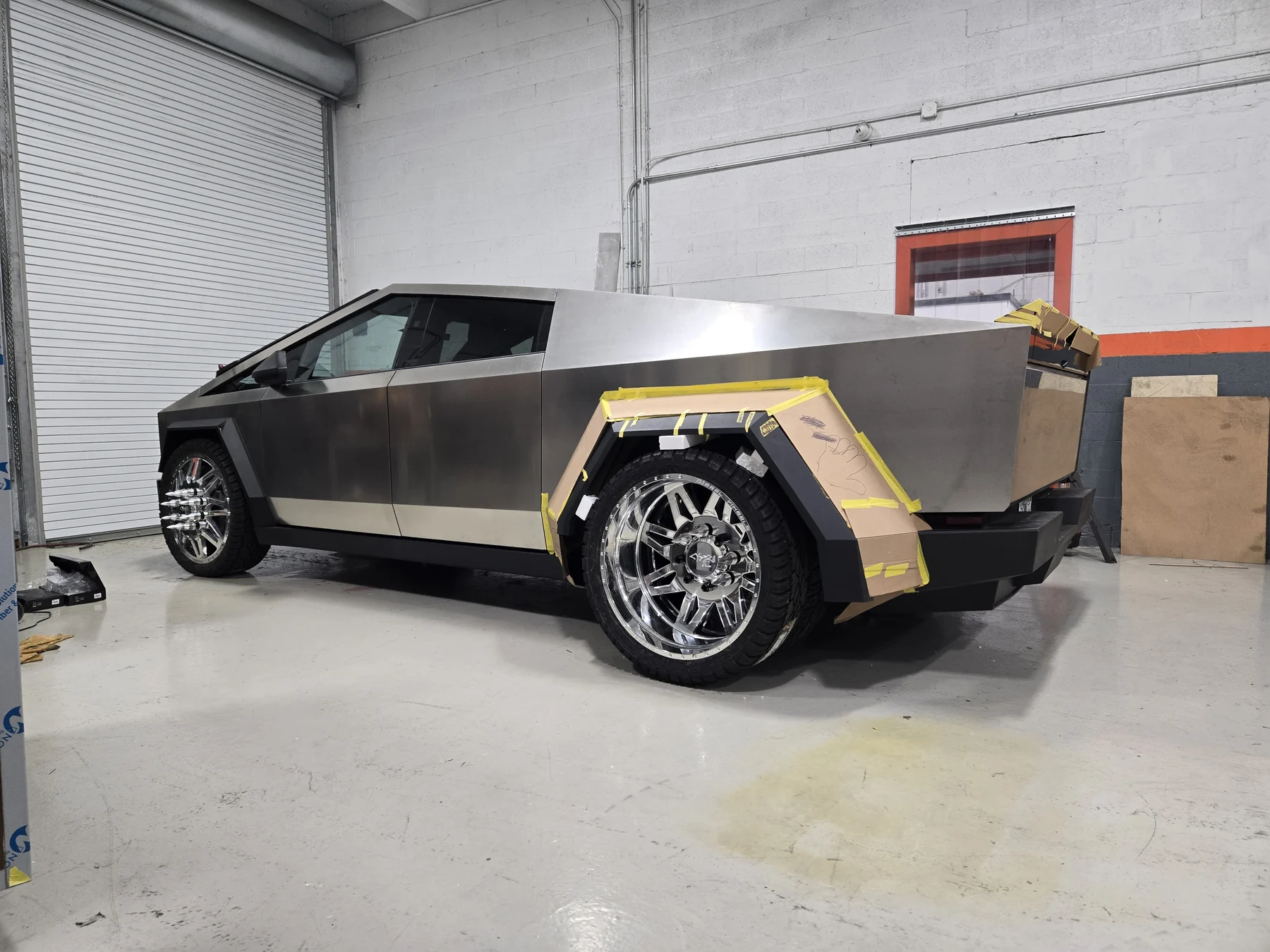 Cyber Dos build in a workshop rear three-quarter view with polished wheels