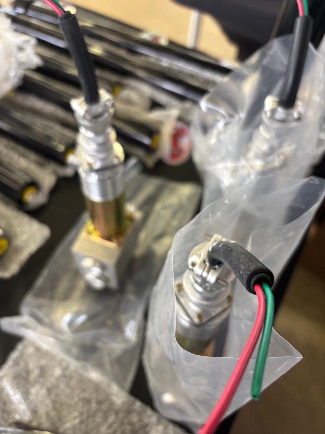 Close-up of Red's Miami hydraulic fittings and wiring at the SEMA product booth